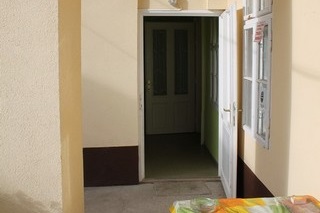A bejárati ajtó előtti fedett gang.